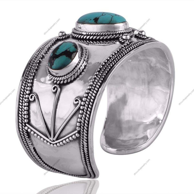 Handcrafted silver turquoise cuff bracelet with intricate metalwork and vibrant gemstones