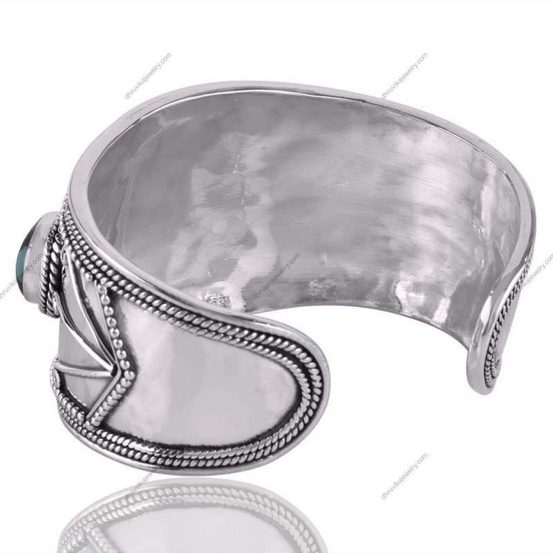 Handcrafted silver turquoise cuff bracelet with intricate metalwork and vibrant gemstones