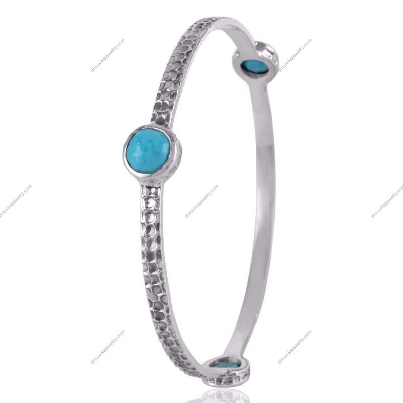 Handcrafted sterling silver turquoise bangle with hammered texture and natural gemstone accents