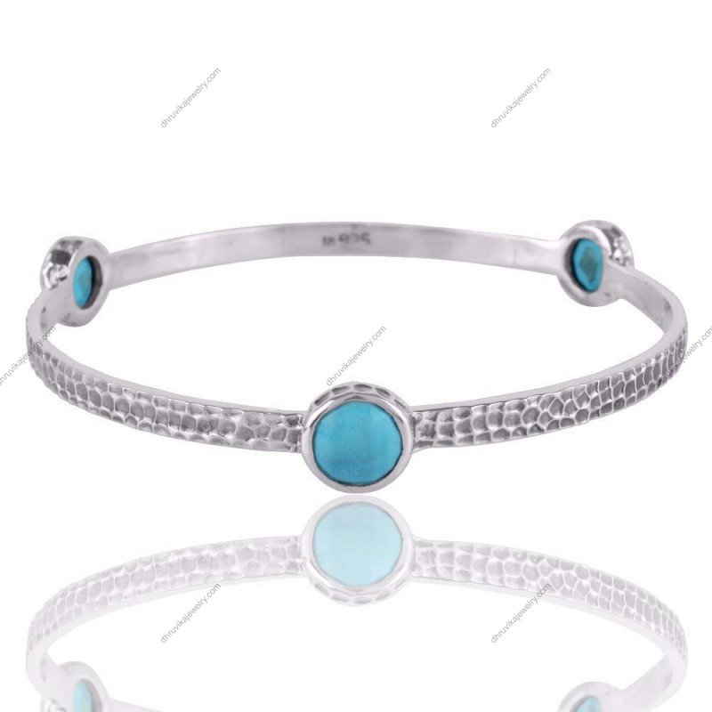 Handcrafted sterling silver turquoise bangle with hammered texture and natural gemstone accents