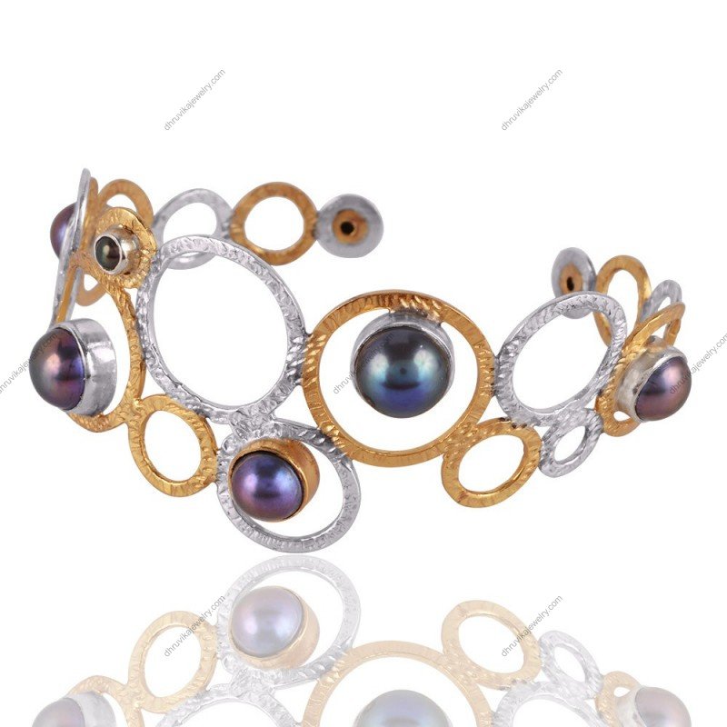 Handmade silver and gold cuff bracelet with black pearls in an openwork design