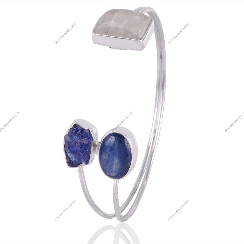 Handcrafted silver cuff bracelet with kyanite, tanzanite, and moonstone gemstones, adjustable fit, artisan design.