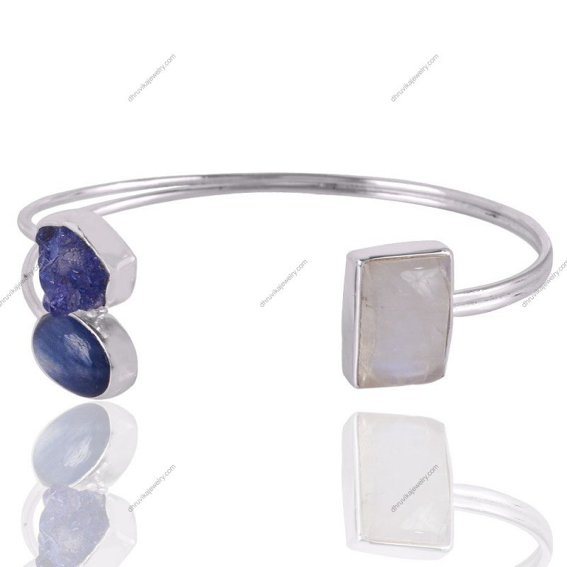 Handcrafted silver cuff bracelet with kyanite, tanzanite, and moonstone gemstones, adjustable fit, artisan design.
