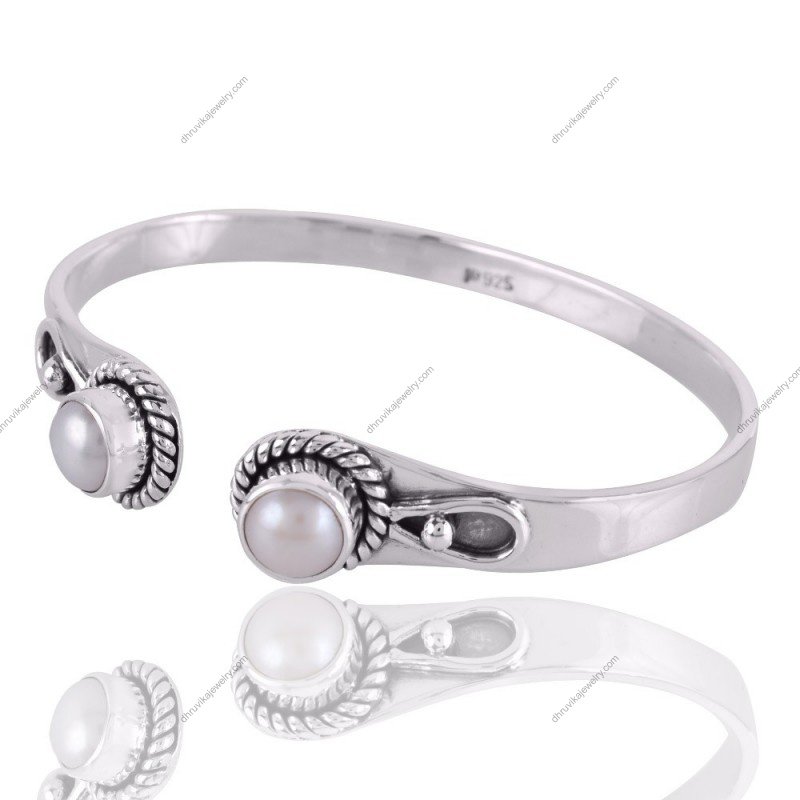 Sterling silver pearl cuff bracelet with intricate rope detailing and freshwater pearls