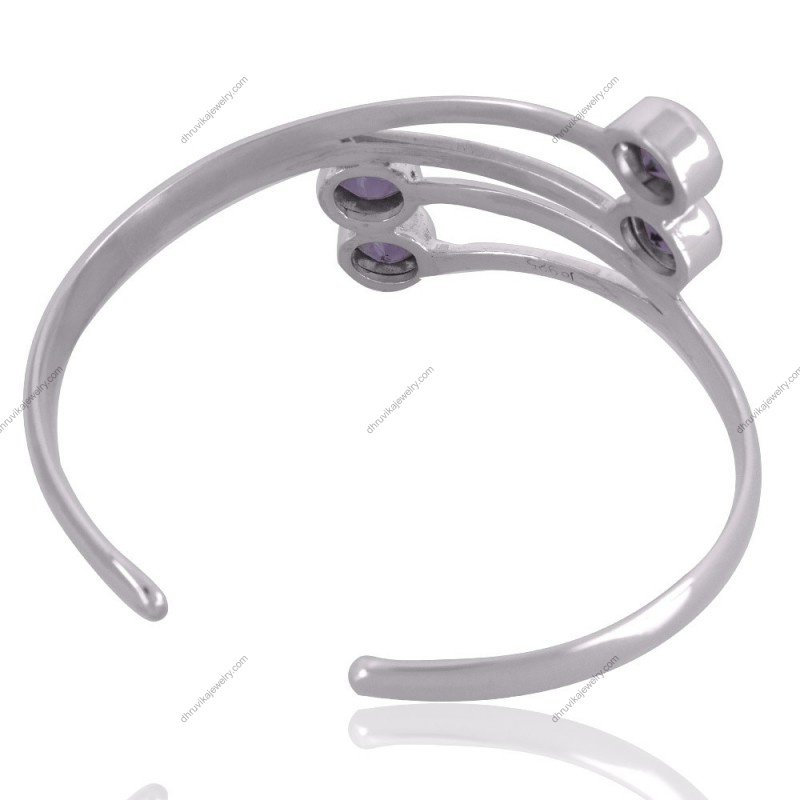 Sterling silver amethyst cuff bracelet with four round-cut gemstones, handcrafted for timeless elegance.