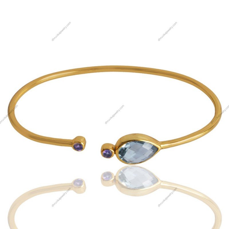 Gold-plated open cuff bracelet with blue topaz and amethyst gemstones, elegant and handcrafted. view1