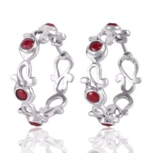 Sterling silver ruby hoop earrings with intricate scrollwork and red gemstone accents main view