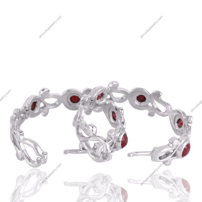 Sterling silver ruby hoop earrings with intricate scrollwork and red gemstone accents view1