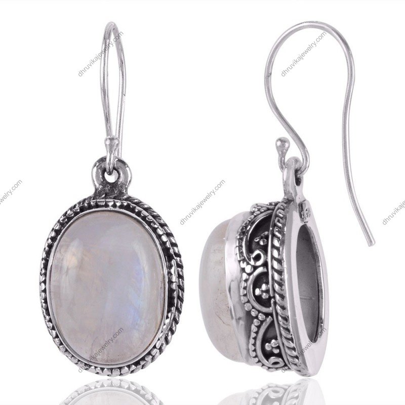 Handcrafted silver moonstone dangle earrings with sterling silver detailing and an iridescent glow view1