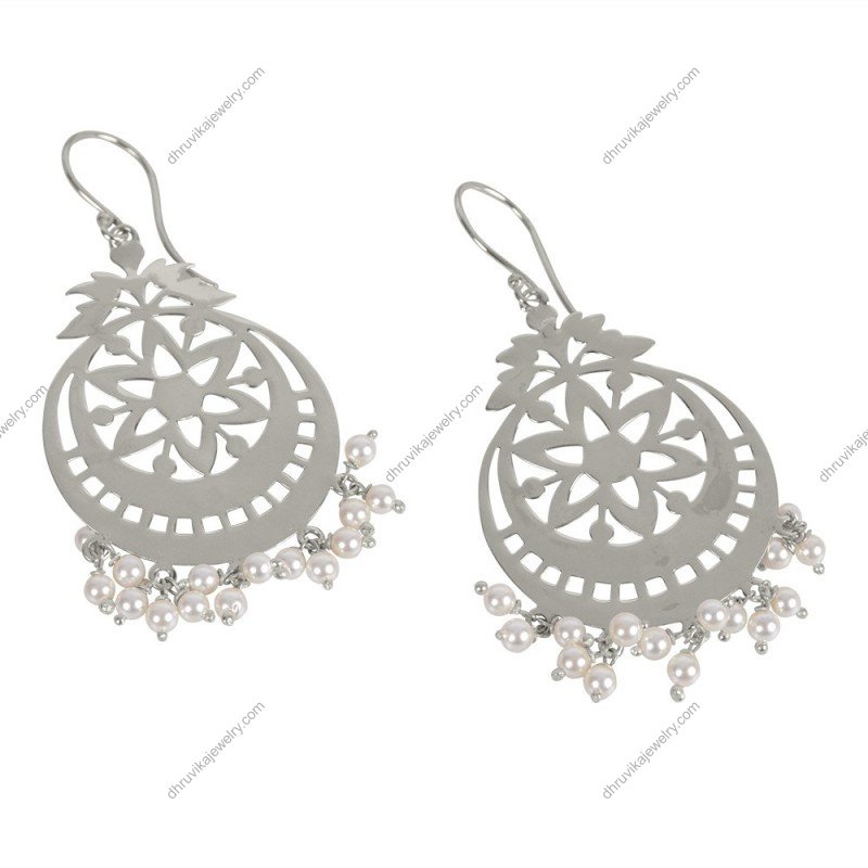 Silver chandelier earrings with intricate floral cutout design and pearl drop accents for an elegant look. alternate image
