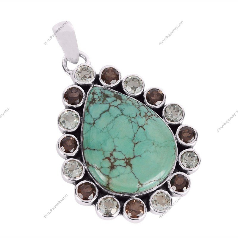 Sterling silver turquoise teardrop pendant with gemstone halo, handcrafted in an elegant design. alternate image