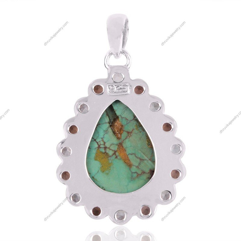 Sterling silver turquoise teardrop pendant with gemstone halo, handcrafted in an elegant design. view1
