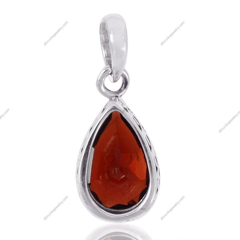 Sterling silver garnet teardrop pendant with faceted red gemstone in elegant setting view1