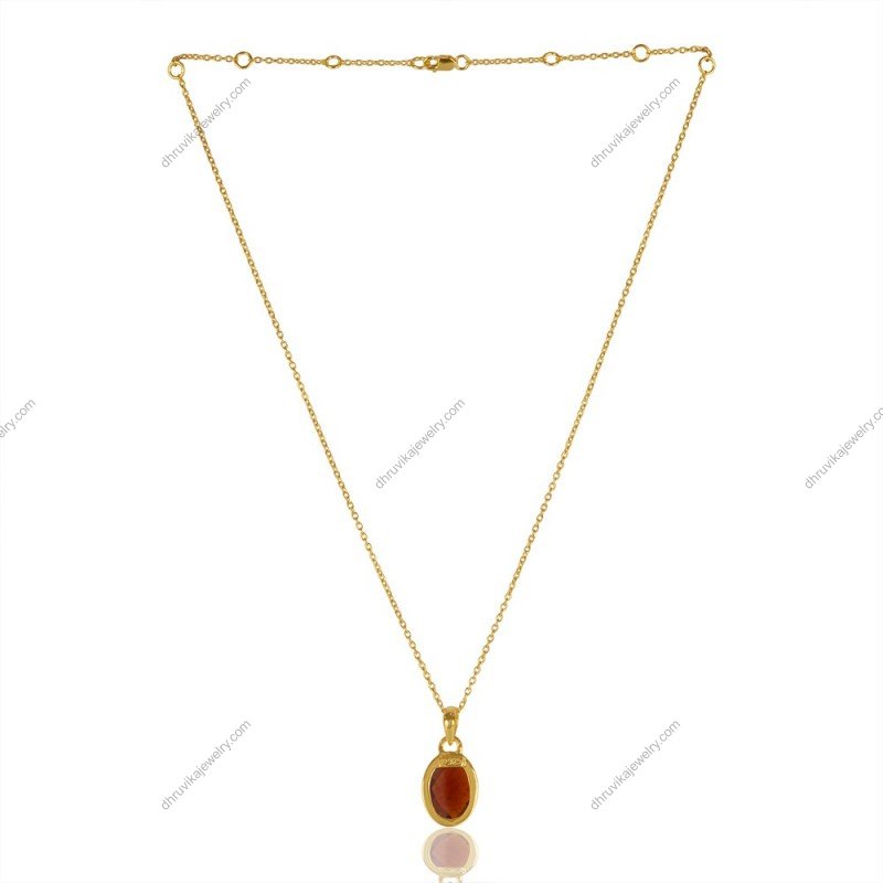 Gold-plated garnet pendant necklace with faceted gemstone on delicate chain view1