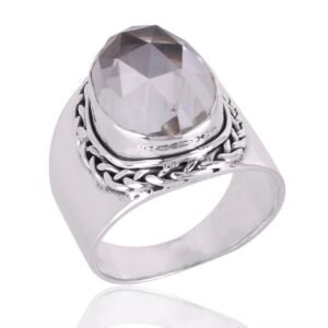 Sterling silver clear quartz statement ring with oval-cut gemstone and intricate silver band. main view